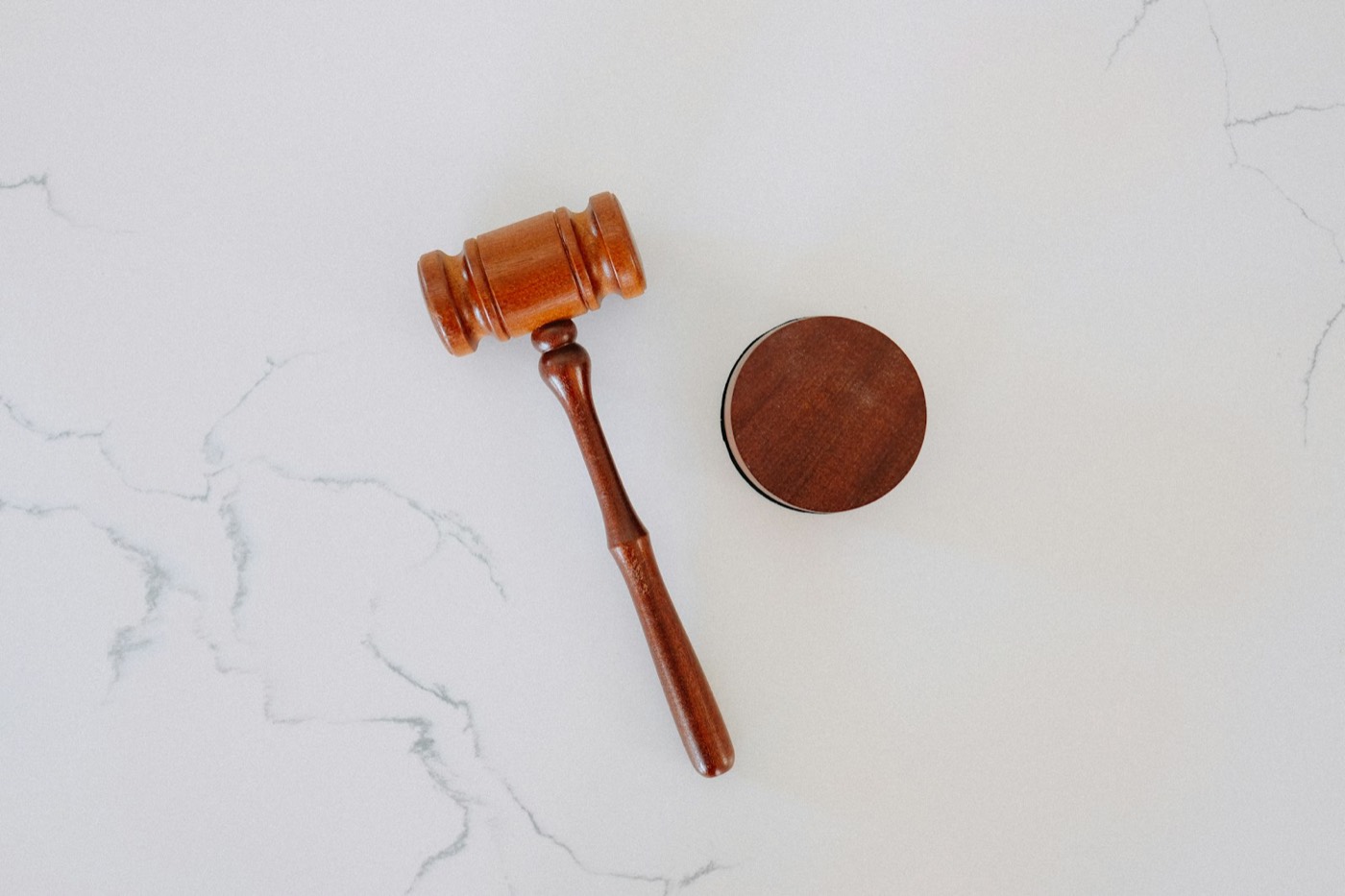 An auctioneer's gavel resting on a marble surface
