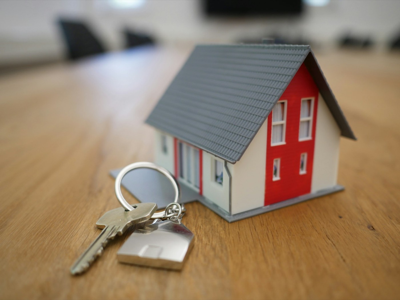 A model house and a set of keys resting on a table